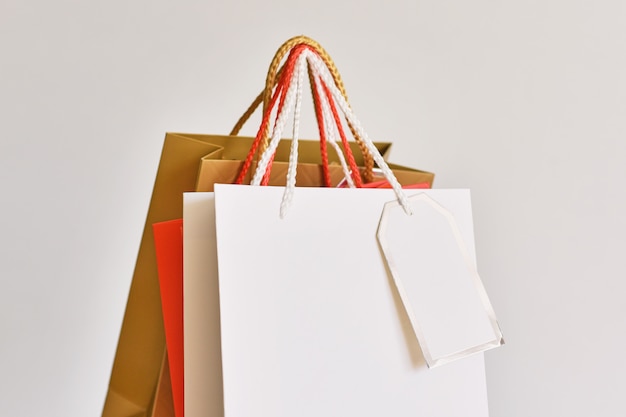 Colorful paper shopping bag on white, close up