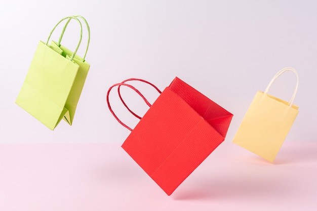 Colorful paper shopping bags on bright background