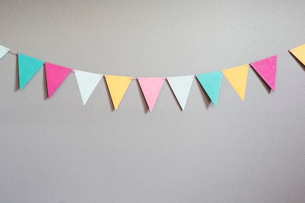 colorful party flags over cement concrete gray wall texture wall pastel birthday colored 