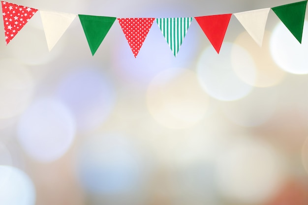 Colorful party flags hanging on blur abstract background