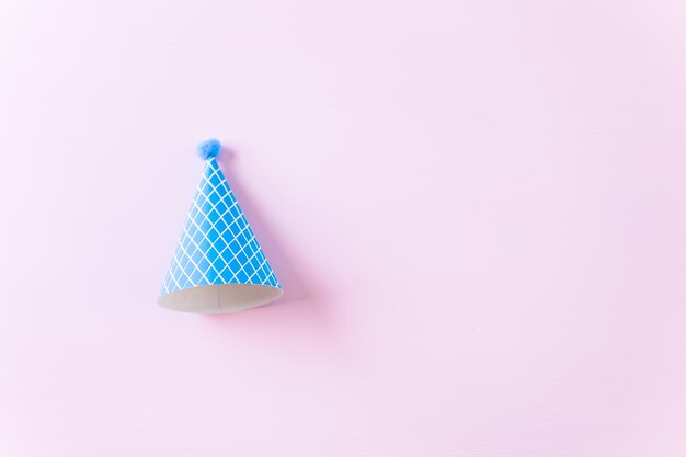 Colorful party hats for kids Birthday Party on pink background.