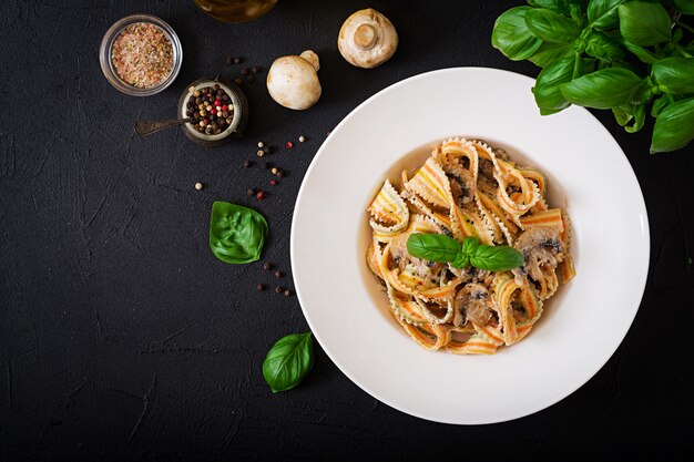 Colorful Pasta pappardelle with mushrooms in cream sauce. Flat lay. Top view