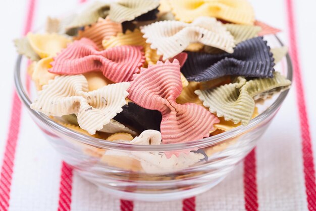 Colorful pasta on tablecloth background