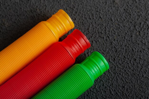 Colorful pattern of antistress fidget pop tube sensory toy on concrete background