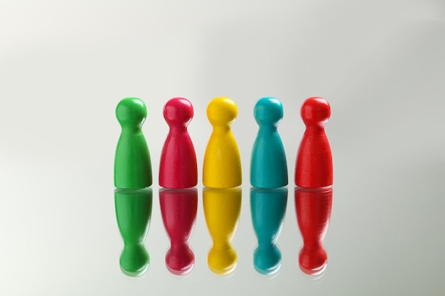 Colorful pawns on white background Social inclusion concept