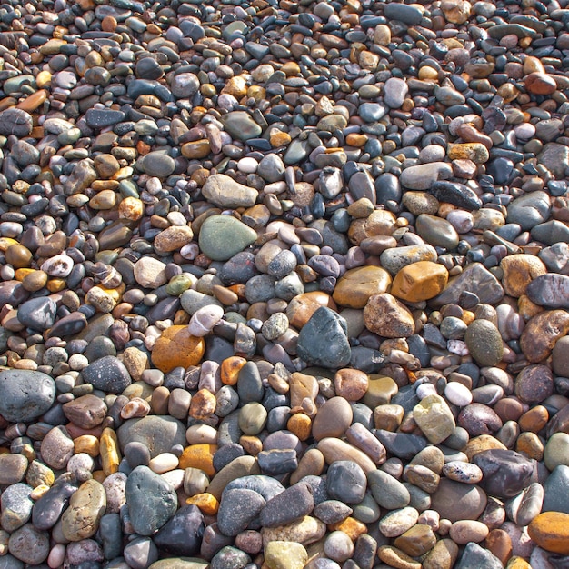 Colorful pebble beach near seashore background Selective focus