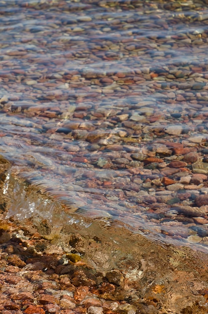 Colorful pebbles in the crystal clear water