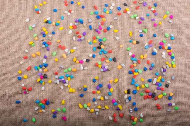 Colorful pebbles spread on canvas background