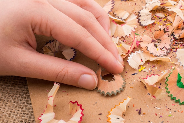 Colorful pencil shavings in hand