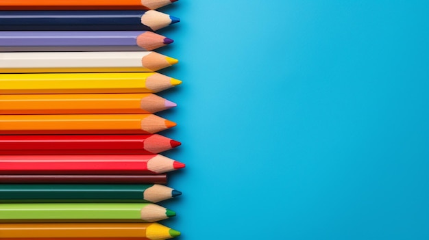 Colorful pencils on blue background with copy space