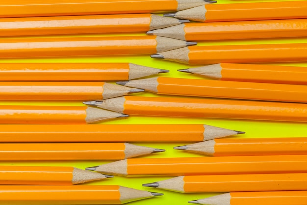 Colorful pencils on a bright green paper