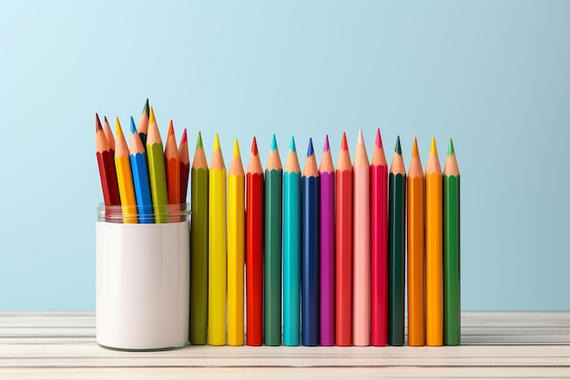 Colorful pencils in a jar on a blue background with copy space