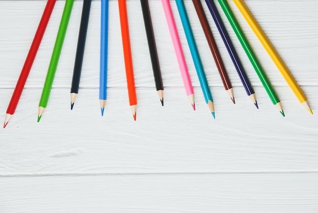 Colorful pencils on white wooden background back to school concept Art creative photo