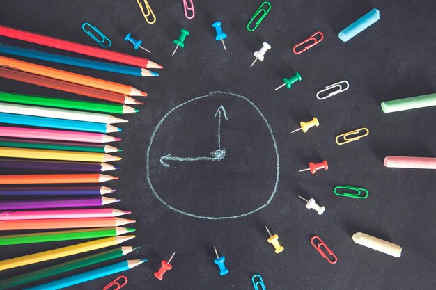 Colorful pencils with clock