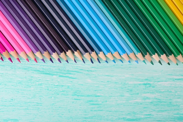 Colorful pencils on wooden table