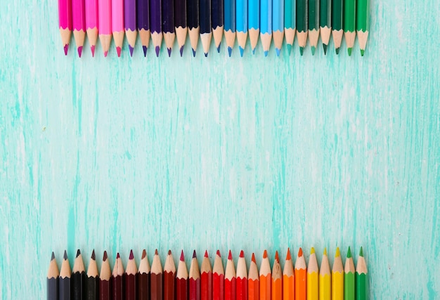 Colorful pencils on wooden table