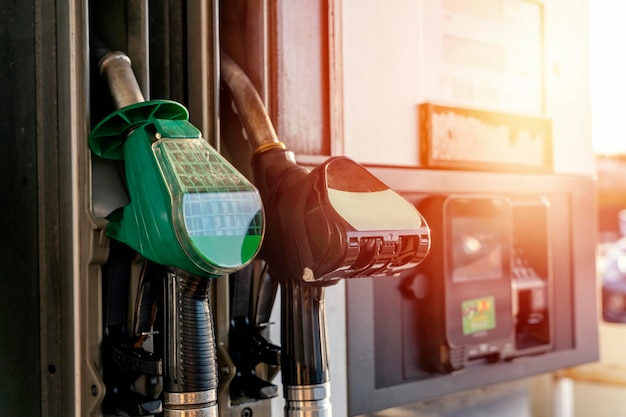 Photo colorful petrol and diesel nozzles of the dispenser machine at the gas fuel station