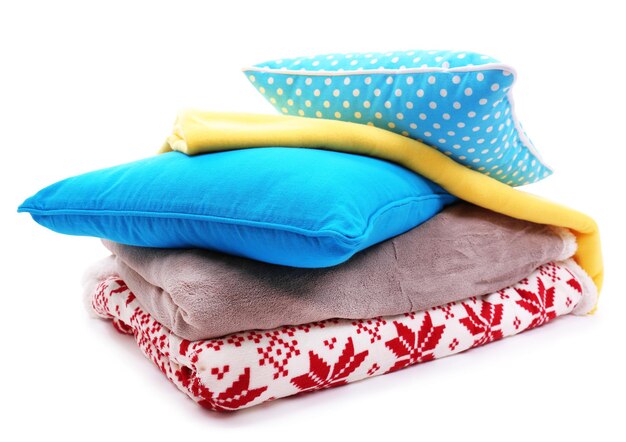 Colorful pillows and plaids isolated on white