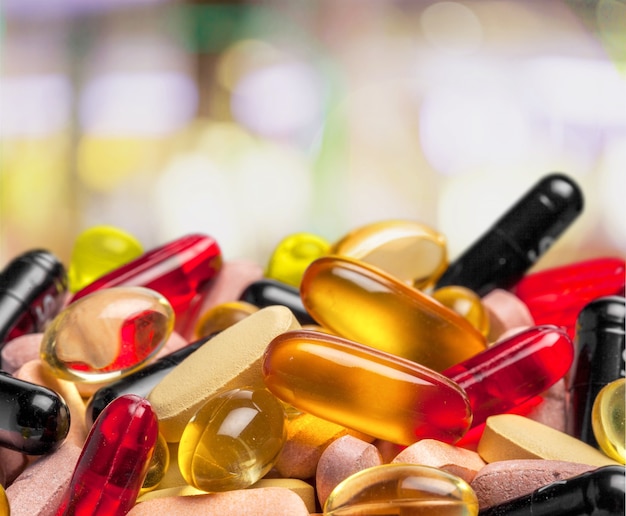 Colorful pills and tablets on background