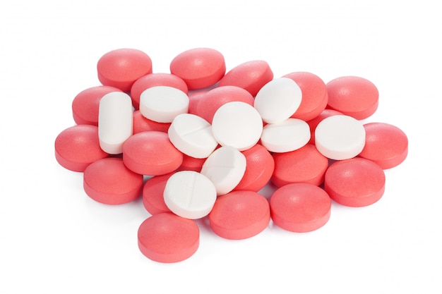 Colorful pills on white surface