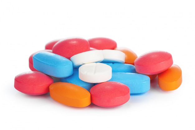 Colorful pills on white surface