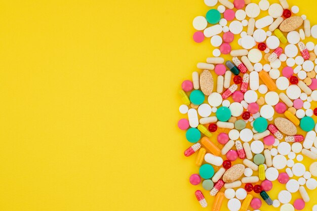 colorful pills on yellow