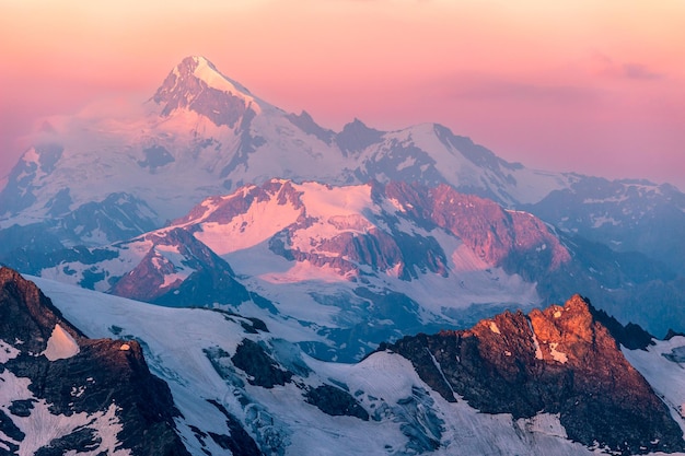 Colorful pink sunrise in mountains. Caucasus, Russia.