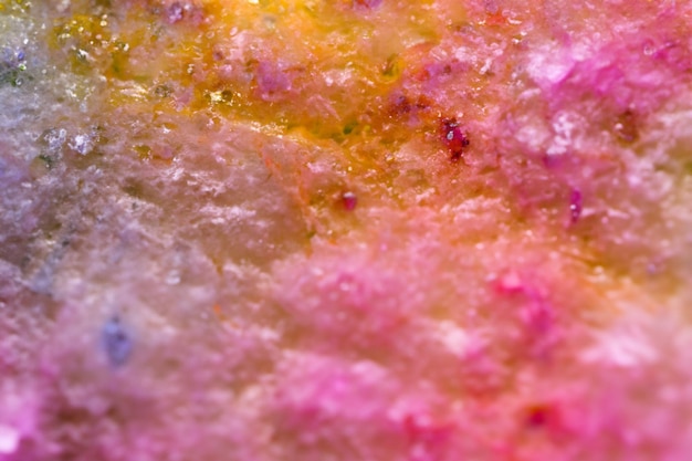 A colorful, pink, and yellow marble with the word mineral on it.