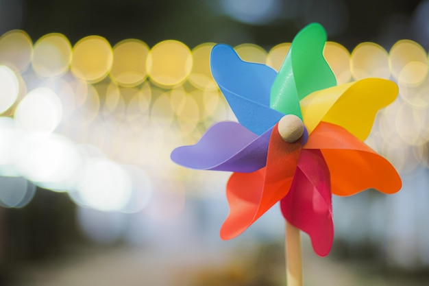 Colorful pinwheel with golden bokeh background