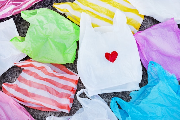 Colorful plastic bags on cement floor 