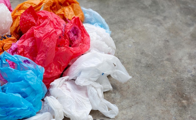 Colorful plastic bags on cement floor