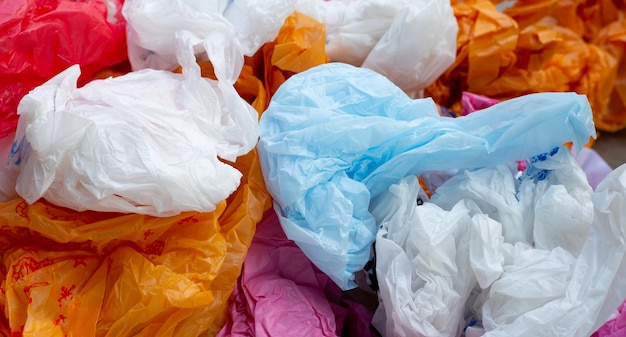 Colorful plastic bags on cement floor