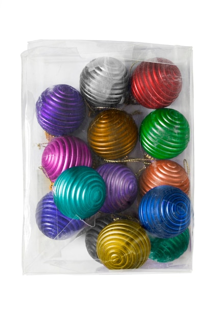 Colorful plastic christmas balls in plastic box on white background