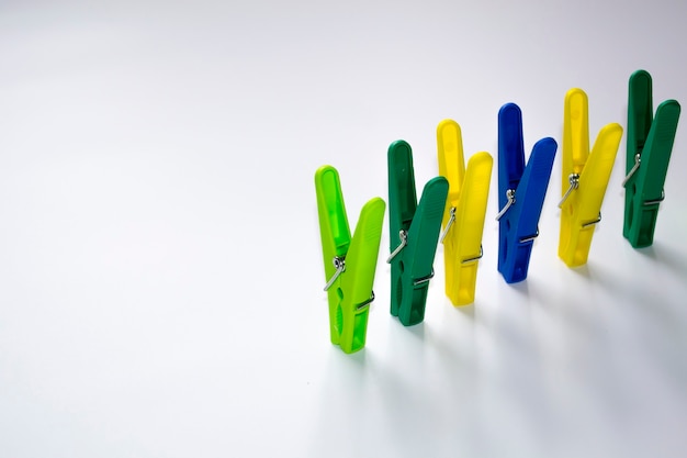 Colorful plastic clothespins on a light background space for your inscription minimalism original an...