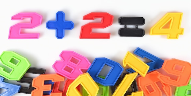 Photo colorful plastic numbers on a white