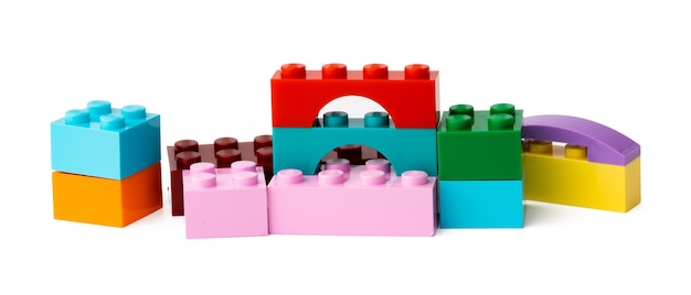 Colorful plastic toy building blocks isolated on white