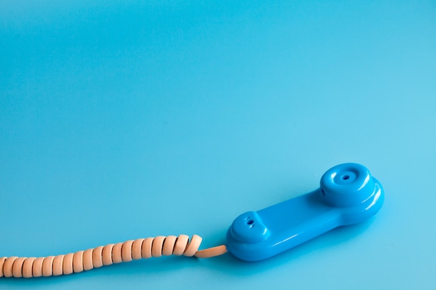 Colorful plastic toy mobile phone on blue