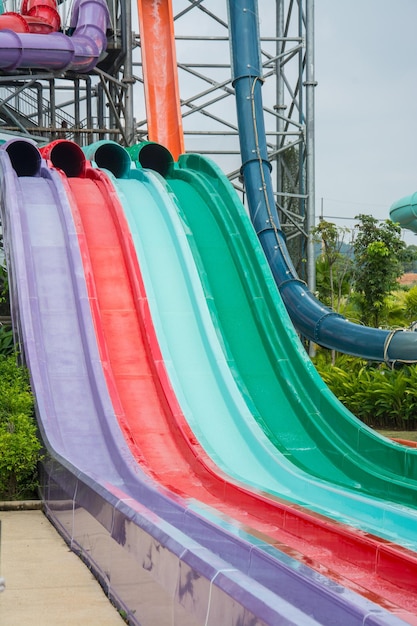 Colorful plastic waterslide in swimming pool