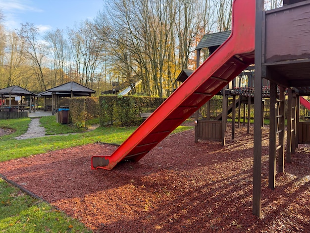 Colorful playground with climbing stairs and slides on yard in the park