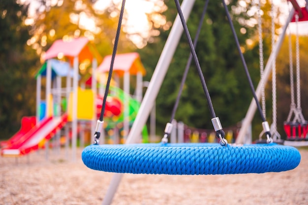 Colorful playground on yard in the park Colorful children playground activities in public park surrounded by green trees