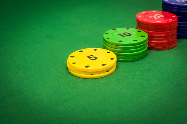 Colorful poker chips on poker table