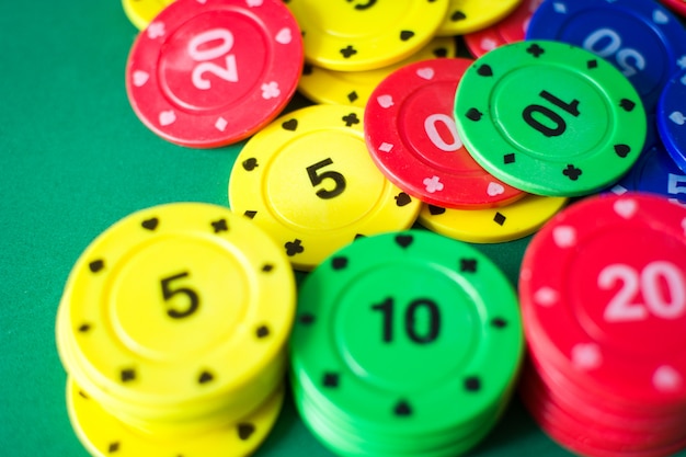 Colorful poker chips on poker table