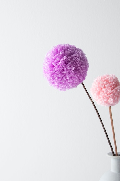 Colorful pom poms in vase assortment