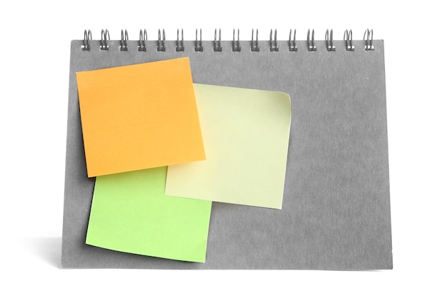 colorful post it paste on notebook on white background 