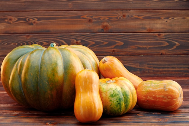 Colorful pumpkins on brown wooden table