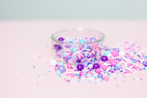 Colorful purple sprinkle blend on a pink background.