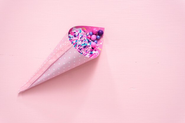 Colorful purple sprinkle blend on a pink background.