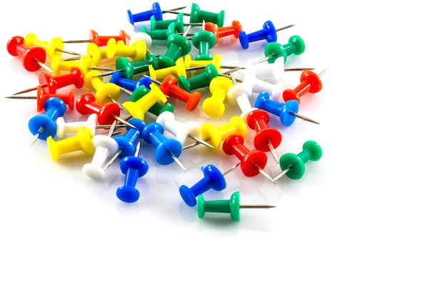 colorful push pins on white background.