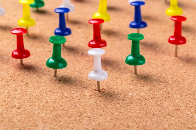 colorful pushpins pinned to bulletin board