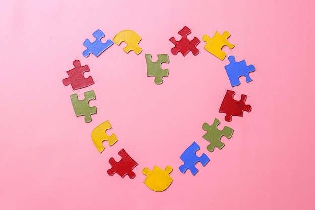 Photo colorful puzzle forming a heart shape. world autism awareness day.